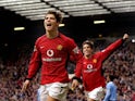 Manchester United's Cristian Ronaldo (L) celebrates after scoring his team's third goal as teammate Ruud Van Nistelrooy (R) runs behind him on February 14, 2004