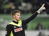Timo Horn raises his hand during the German first division Bundesliga football match VfL Wolfsburg vs 1 FC Koln at the Volkswagen Arena in Wolfsburg, central Germany on December 20, 2014