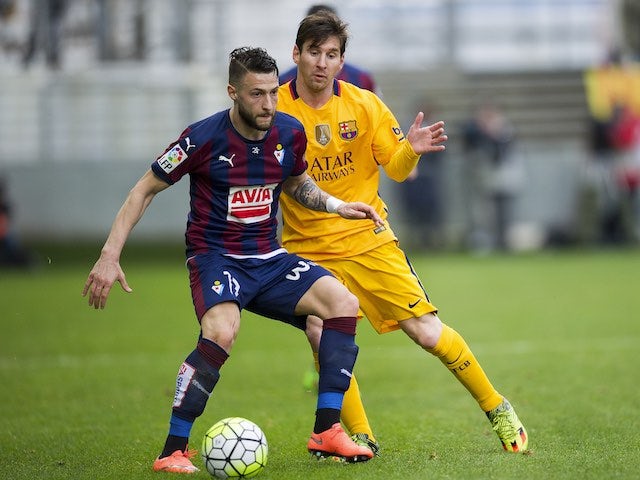David Junca 'inyatrunca' and Lionel Messi in action during the La Liga game between Eibar and Barcelona on March 6, 2016