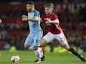 Luke Shaw and Sergio Aguero in action in the match between Manchester United and Manchester City on October 26, 2016