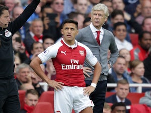 Arsene Wenger brings on Alexis Sanchez during the Premier League game between Arsenal and Bournemouth on September 9, 2017
