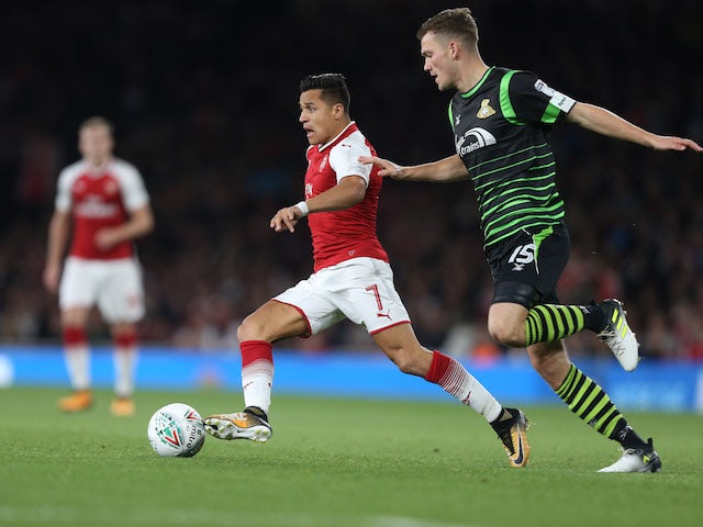 A terrified Alexis Sanchez is pursued by Joe Wright during the EFL Cup game between Arsenal and Doncaster Rovers on September 20, 2017