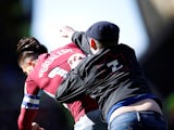 A Birmingham City fan punches Aston Villa midfielder Jack Grealish on March 9, 2019
