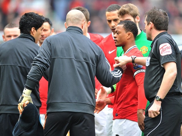 Evra, Suarez share a pre-match handshake