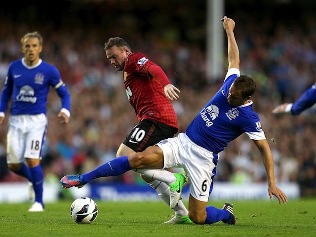 Rooney happy to fight for place