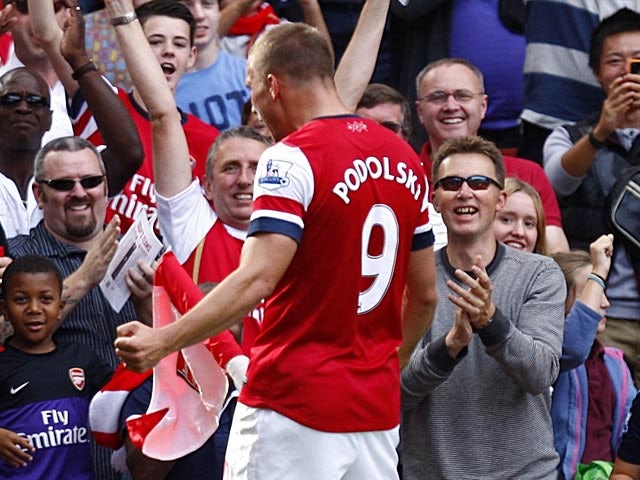 Podolski calms Arsenal title talk