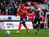 Oldham Athletic's Reece Wabara and Sheffield United's Marcus Williams