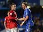 Wayne Rooney helps Fernando Torres to his feet