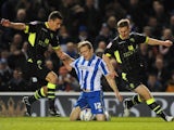 Brighton & Hove Albion's Craig Mackail-Smith is fouled by Leeds United's Jason Pearce and Tom Lees
