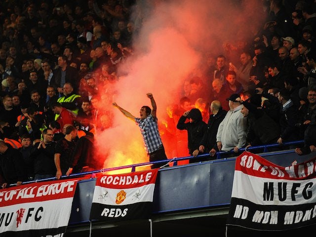 United fans let off a flare in the stands