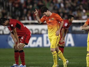 Two-goal Messi helps Barca stay top