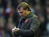 Brendan Rodgers makes notes on the touchline