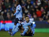 Adel Taarabt sits on the ground after a missed chance