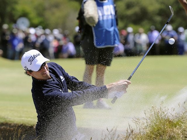 Adam Scott hits out of a bunker on November 17, 2012