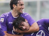 Luca Toni gets Alberto Aquilani in a headlock after he scores for Fiorentina on November 18, 2012