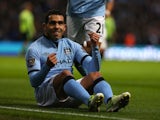 Carlos Tevez celebrating from the ground after scoring on November 17, 2012