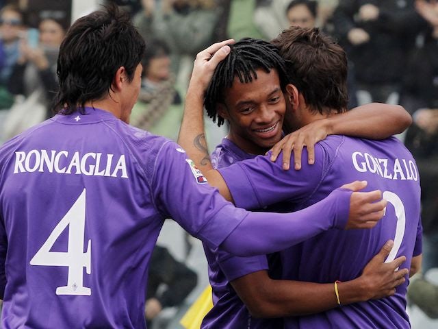 Gonzalo is hugged by Fiorentina teammates after scoring on November 18, 2012