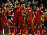 Jose Enrique celebrates with Liverpool teammates on November 17, 2012