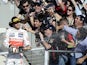 Lewis Hamilton smiles and sprays after winning the US Grand Prix on November 18, 2012