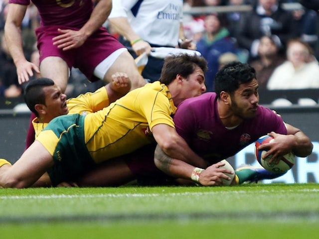 England's Manu Tulagi slides in a try against Australia on November 17, 2012