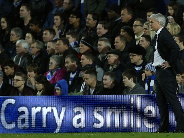 An advertising board encourages Mark Hughes to smile on November 17, 2012