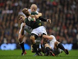 South Africa's JP Pietersen is held back by England's Tom Youngs and Joe Launchbury on November 24, 2012