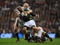 South Africa's JP Pietersen is held back by England's Tom Youngs and Joe Launchbury on November 24, 2012