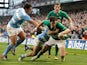  Ireland's Jonathan Sexton skips past Argentina's Eusebio Guinazu and Martin Landajo to score a try on November 24, 2012
