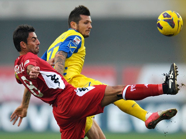 Chievo's Cyril Thereau and Siena's Simone Vergassola battle for the ball on November 25, 2012