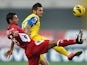 Chievo's Cyril Thereau and Siena's Simone Vergassola battle for the ball on November 25, 2012