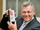 Darren Clarke receives an OBE for services to golf on November 21, 2012