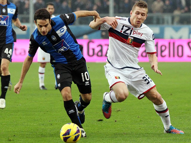 Genoa's Juraj Kucka and Atalanta's Giacomo Bonaventura battle for the ball on November 25, 2012