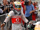 Lewis Hamilton celebrates moments after clocking the fastest qualifying time to secure pole position at Interlagos on November 24, 2012