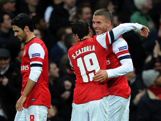 Lukas Podolski celebrates scoring a pretty-special-too goal for Arsenal on November 21, 2012