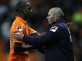 Blackpool boss Michael Appleton shakes the hand of goalscorer Isaiah Osbourne on November 24, 2012