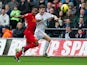 Raheem Sterling tugs the shirt of Ben Davies as they chase the ball on November 25, 2012