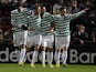 Celtic players celebrate their third goal against Hearts player Ryan Stevenson scores an own goal on November 28, 2012