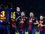 Cesc Fabregas is congratulated by his team mates after scoring his team's fourth goal on December 1, 2012