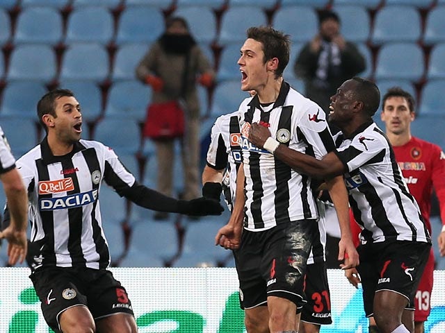 Udinese's Gabriele Angella celebrates with team mates after scoring his team's second goal on December 2, 2012