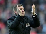 MK Dons manager Karl Robinson claps after the FA Cup match against AFC Wimbledon on December 2, 2012