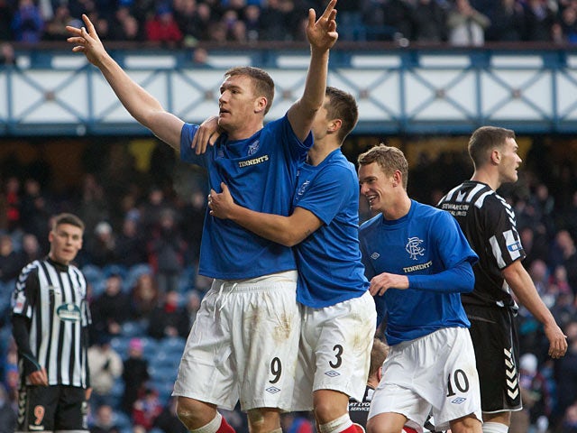 Rangers' Kevin Kyle is congratulated by team mates after scoring his team's second goal on December 2, 2012