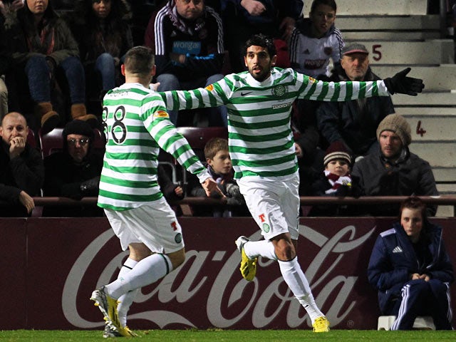 Lassad Nouioui celebrates with team mate Gary Hooper after scoring the opener against Hearts on November 28, 2012