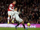 Leon Britton attempts to block Lukas Podolski's shot on goal on December 1, 2012