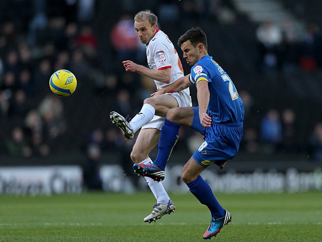 MK Dons' Luke Chadwick and AFC Wimbledon's Steven Gregory battle for the ball on December 2, 2012