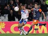 Lyon's Michel Bastos and Montpellier's Marco Estrada battle for the ball on December 1, 2012