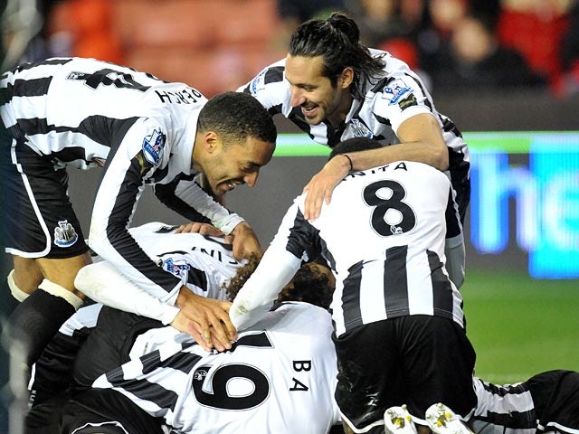 Papiss Cisse is mobbed by team mates after scoring the opener against Stoke on November 28, 2012