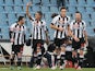 Udinese's Roberto Pereyra is congratulated by team mates after scoring the opener against Cagliari on December 2, 2012