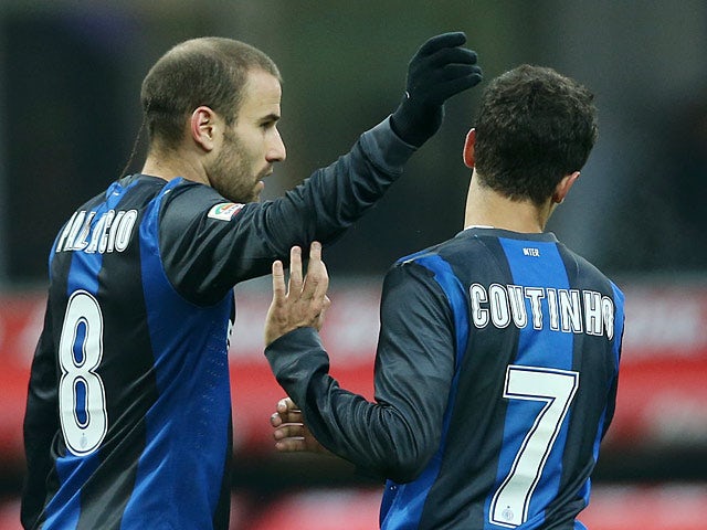Rodrigo Palacio and team mate Coutinho celebrate after opposition Palermo score an own goal on December 2, 2012