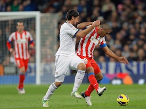 Real Madrid's Sami Khedira and Atletico Madrid's Cata Diaz battle for the ball on December 1, 2012