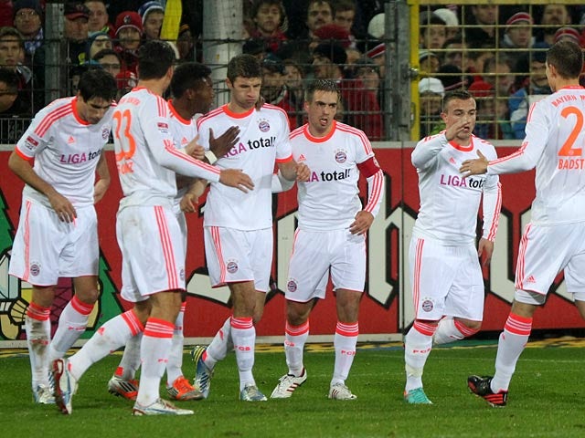 Thomas Mueller is congratulated by his team mates moments after scoring the opener on November 28, 2012